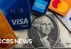 Record number of Americans carrying credit card debt they can't pay off, report shows