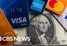 Record number of Americans carrying credit card debt they can't pay off, report shows