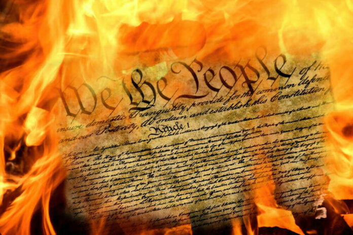 Burning U.S. Constitution amidst flames.