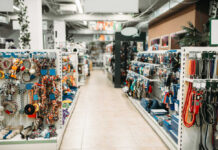 Pet store aisle with shelves of dog toys, leashes, and collars