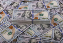 Stack of one hundred dollar bills, Benjamin Franklins portrait.