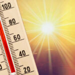 Thermometer shows high temperature under scorching sun.
