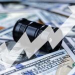 An oil barrel placed on a background of dollar bills with an upward trend graph overlay