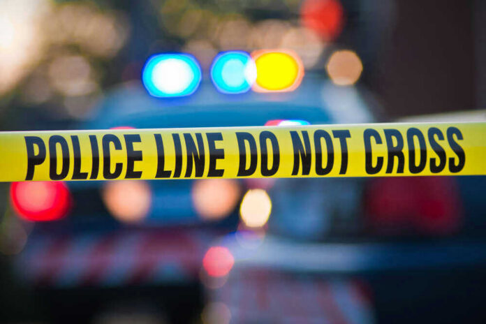 shutterstock_56280433 Police tape and lights at crime scene.