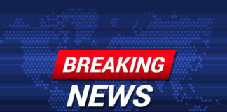 Breaking News text on world map background.