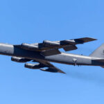 B-52 bomber flying against a clear blue sky
