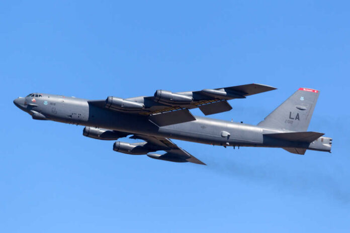Avalon,,Victoria,,Australia,-,March,4,,2013:,United,States,Air B-52 bomber flying against a clear blue sky