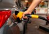 A person refueling a car at a gas station