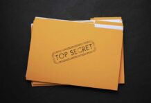 Yellow folder labeled Top Secret on black background.