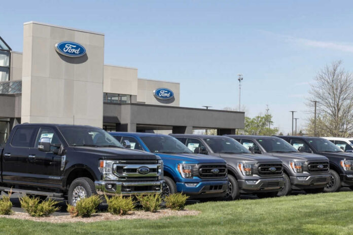 shutterstock_2289162811 Ford dealership with trucks lined up outside