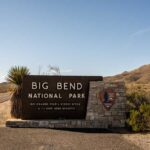 Big Bend National Park entrance sign by desert road