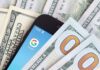 Smartphone with Google app on screen among US dollar bills