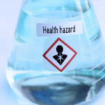 Flask labeled Health hazard with warning symbol.