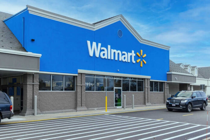 shutterstock_2415634825 Walmart store exterior with parked cars
