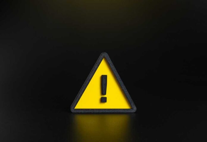 Attention,Sign.,Exclamation,Point,In,A,Yellow,Triangle.,Important,Message. Yellow triangular warning sign with exclamation mark on black background