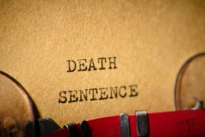 Death,Sentence,Text,Written,With,A,Typewriter. Typewriter typing the words death sentence on paper