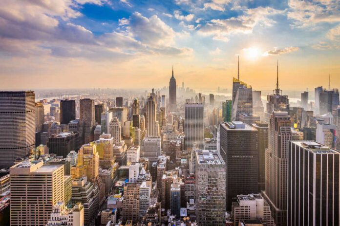 City skyline with skyscrapers at sunset.