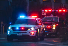 Police car and ambulance with flashing lights nighttime