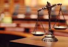 Scales of justice in an empty courtroom.