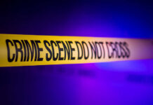 Yellow crime scene tape with the words 'CRIME SCENE DO NOT CROSS'