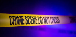 Yellow crime scene tape with the words 'CRIME SCENE DO NOT CROSS'