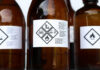 Brown bottles with hazard symbols and warning labels.