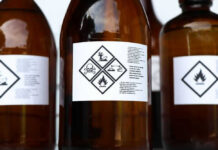Brown bottles with hazard symbols and warning labels.
