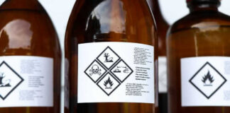 Brown bottles with hazard symbols and warning labels.