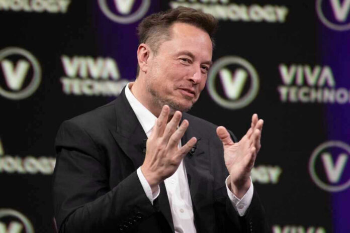 Elon Musk speaking on stage with hands raised during a talk