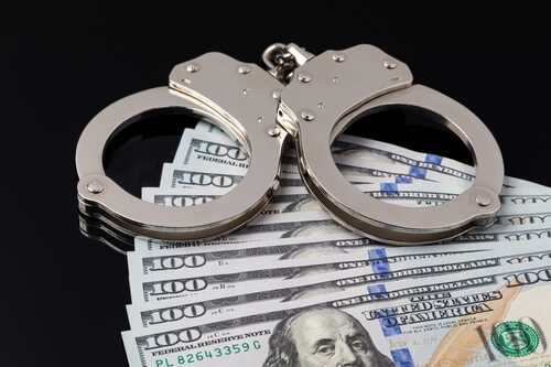 Handcuffs,With,Cash,Money,Isolated,On,Black,Background.,Cash,Bail Handcuffs resting on a stack of hundred dollar bills