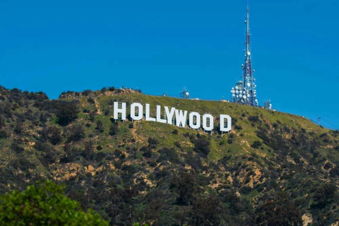 shutterstock_2379716613 Hollywood sign on a green mountain hillside.