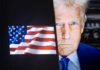 Donald Trump face beside a display of the American flag